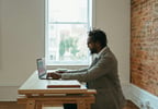 Person using a laptop near window